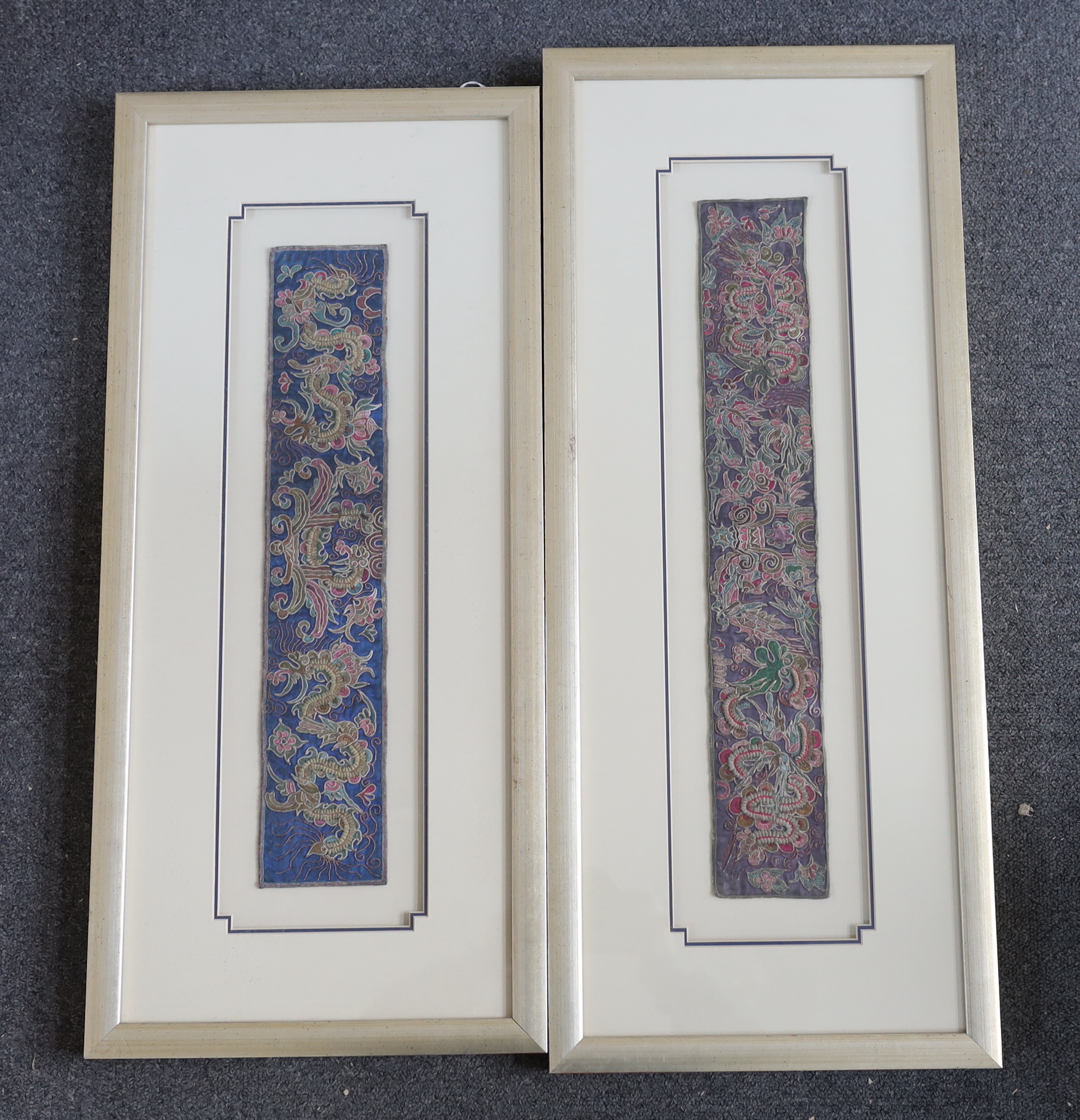 Two 19th century Chinese sleeve bands, embroidered in rich polychromes silks, designed with unusual fine appliqué embroidery, giving the panels a three dimensional effect, largest: 8cm wide, 50cm long